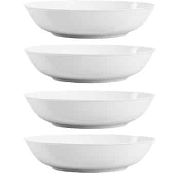 Four plain white shallow bowls are stacked in a vertical row against a white background, each bowl slightly separated from the others—perfect for serving my favorite easy dinner ideas.