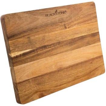 A rectangular wooden cutting board with visible grain patterns and the brand name "Blackstone" engraved on the top edge—perfect for prepping my favorite easy dinner ideas.