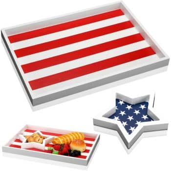 Rectangular tray with red and white stripes resembling the American flag, and a star-shaped tray with a blue background and white stars. Both trays are used to serve assorted snacks and fruit.