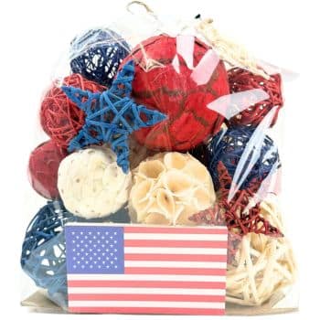 A clear bag contains decorative rattan balls and star shapes in red, white, and blue. An American flag sticker is attached to the front of the bag.