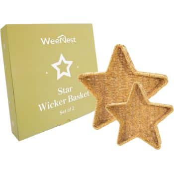 Two star-shaped wicker baskets are shown in front of a green WeeNest box labeled "Star Wicker Basket Set of 2." The baskets are made of woven material and are positioned overlapping each other.