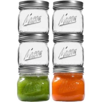 Six Mason jars are stacked in two columns and three rows—my favorite summer decor to make. The top two rows feature empty jars, while the bottom row displays one jar filled with green contents and another with orange contents.