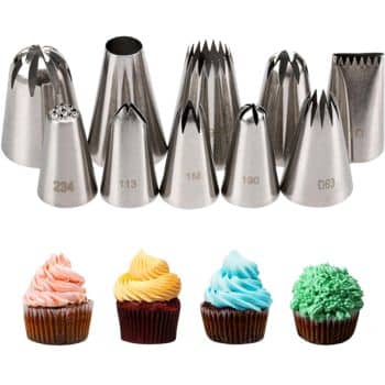 A set of metal piping tips is displayed above four decorated cupcakes—my favorite cakes—each topped with differently styled and colored frosting: pink, yellow, blue, and green.