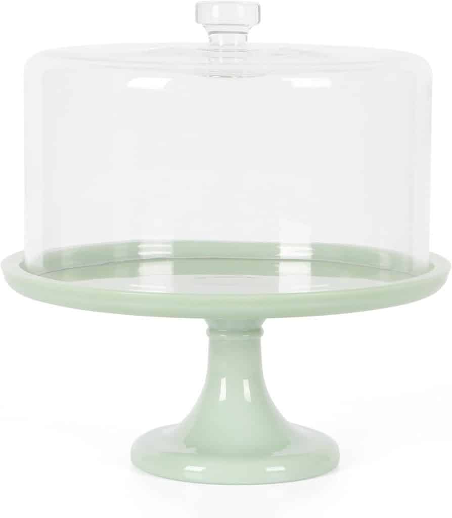 A light green cake stand with a clear glass dome cover, perfect for displaying my favorite cakes. Shown on a white background, the stand has a wide base and a smooth, glossy finish.
