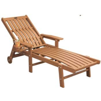 A wooden reclining lounge chair with armrests, small wheels on the back legs, and a built-in cup holder sits alongside outdoor tables and chairs, holding a drink and a straw for added convenience.