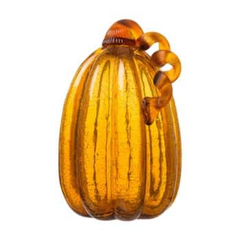 A decorative glass pumpkin with a ribbed texture, amber color, and a curled glass stem on top.