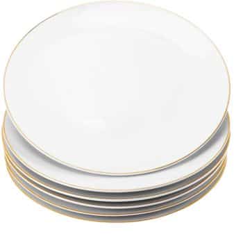 A stack of seven white dinner plates with a thin gold rim, neatly arranged—perfect for serving your favorite easy fall dinners.