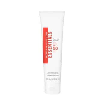 A white tube of Rodan + Fields ESSENTIALS SPF 50 Sunscreen with red and gray text, standing upright against a plain white background.