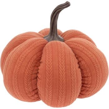 A decorative pumpkin with a soft, textured orange fabric featuring a subtle chevron pattern, and a brown, curved stem on top.