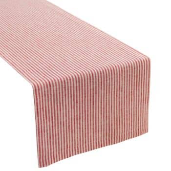 A table runner with red and white vertical stripes draped over the edge of a table.