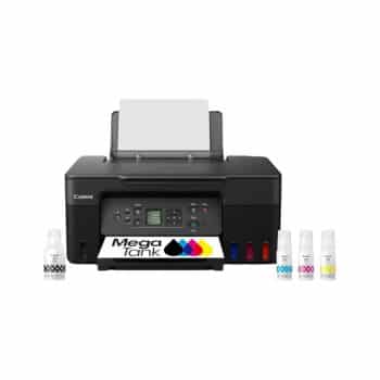 A black Canon MegaTank printer with control buttons and a digital display, paper loaded in the tray, and four ink bottles (black, cyan, magenta, yellow) placed in front of it.