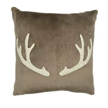 A square, brown throw pillow featuring a white antler design on the front. The antlers are positioned symmetrically, facing each other on the soft fabric.