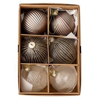 A cardboard box holds six ribbed, spherical Christmas ornaments in metallic shades of bronze, gold, and silver, each separated by cardboard dividers and cushioned with white tissue paper.