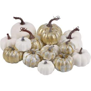 A group of decorative pumpkins in various sizes, perfect for white pumpkin crafts, are arranged together. Some feature metallic gold accents, while others are solid white, all with charming brown stems.