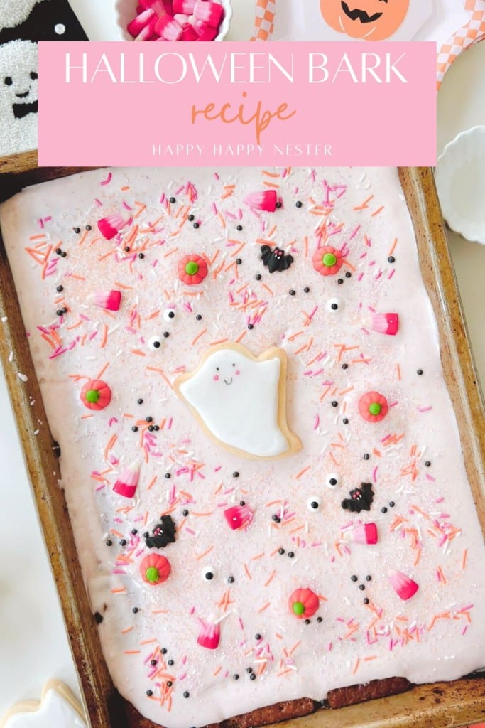 A tray of pink Halloween bark topped with a ghost-shaped cookie, candy eyes, candy corn, sprinkles, and green candies. Try this Halloween bark recipe (easy) for a fun and festive treat! "Halloween Bark Recipe" text at the top.