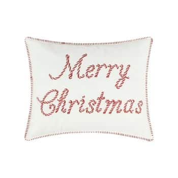 A white rectangular pillow with "Merry Christmas" written in red, candy-cane style lettering and red stitching along the edges.