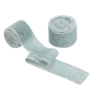 Two light gray, soft, plush fabric strips; one is rolled up while the other is partially unrolled, showing its fluffy texture.