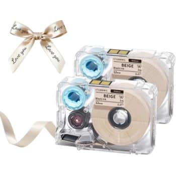 Two clear plastic label tape cartridges with beige tape sit beside a beige ribbon, printed with "Love you" in cursive. The ribbon is tied in a bow—perfect for adding a heartfelt touch to Christmas tree crafts.