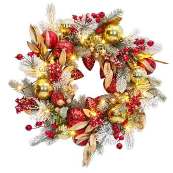 A festive Christmas wreath decorated with red and gold ornaments, pinecones, artificial berries, frosted greenery, and small glowing lights.