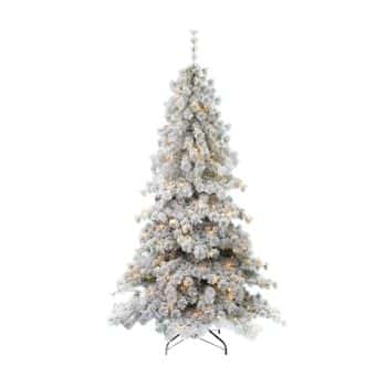 A tall, artificial Christmas tree with snow-frosted branches and warm white lights, standing on a black metal stand against a plain white background.