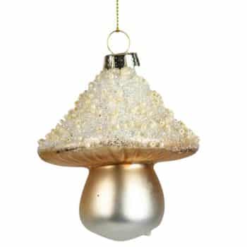 A Christmas tree ornament shaped like a mushroom, with a glittery, beaded white cap and a shiny gold stem, hanging from a thin gold string.