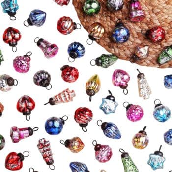 An assortment of colorful, vintage-style glass Christmas ornaments scattered on a white surface, with part of a woven placemat visible in the top right corner—perfect inspiration for my favorite holiday home crafts.