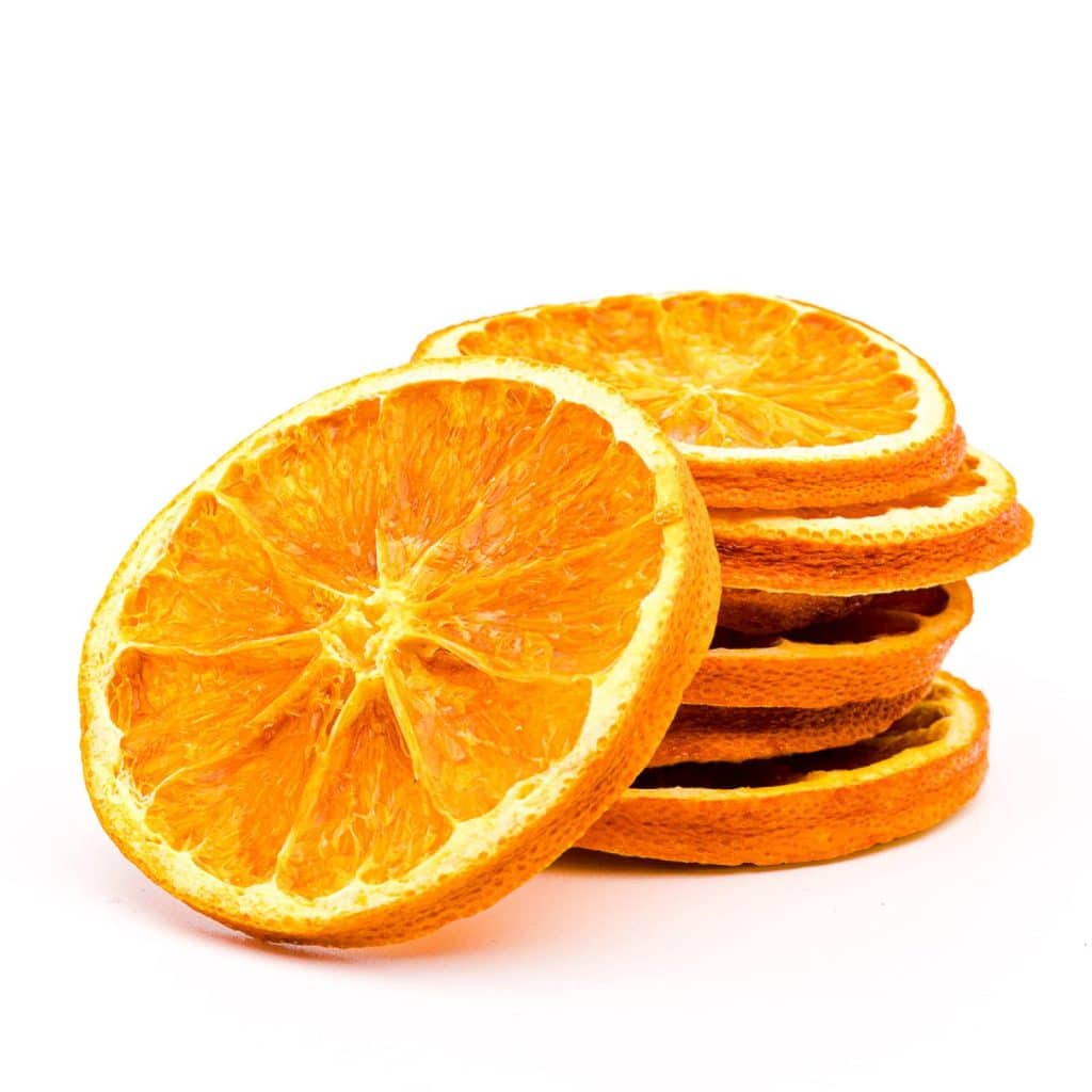 A stack of dried orange slices, with one slice leaning against the pile, displayed on a white background—perfect for my favorite holiday home crafts.