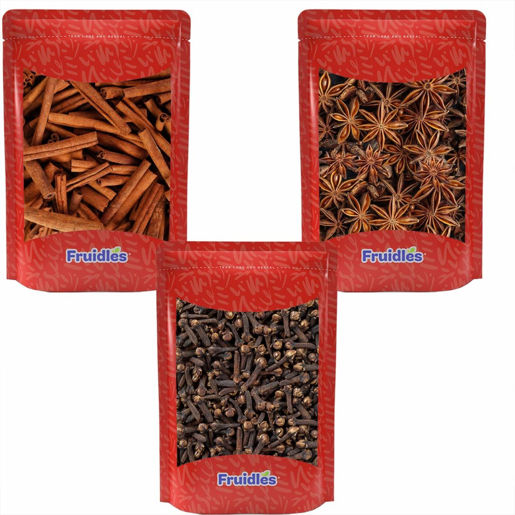 Three red Fruitles branded pouches containing cinnamon sticks, star anise, and whole cloves—ideal for homemade simmer pot recipes or thoughtful simmer pot gifts—are arranged in a triangular layout on a white background.