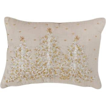 A rectangular beige pillow featuring three embroidered Christmas trees in white and gold thread, with small decorative accents scattered around them.