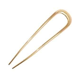 A gold-colored metal hairpin with two prongs and a rounded top, used for securing hair in place.