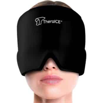 A woman wears a large, black TheraICE cold therapy mask covering her forehead, eyes, and upper cheeks, with only her nose, mouth, and chin visible.