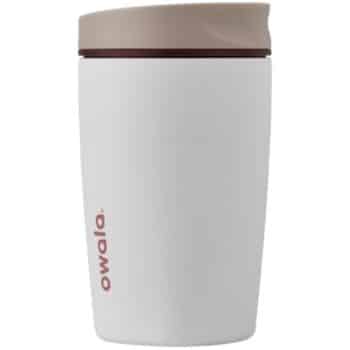 A white Owala travel mug with a beige lid and “owala” written vertically in pink on the side. The mug has a simple, modern design.