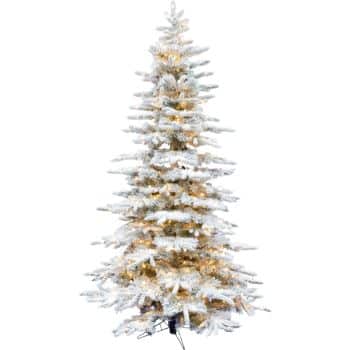 A tall artificial Christmas tree with snow-frosted branches and warm white lights, standing on a black metal stand against a white background—my favorite Christmas decor for creating a festive atmosphere.