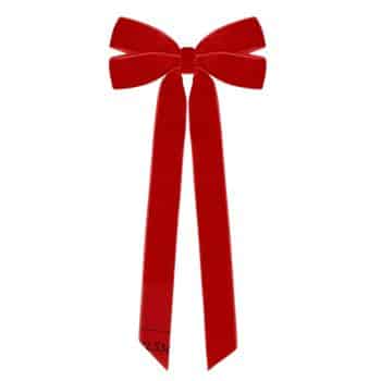 A bright red velvet bow—my favorite Christmas decor—with two long trailing ribbons hanging down, displayed on a plain white background.