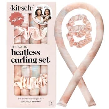 A boxed satin heatless curling set by Kitsch is shown, featuring a long, pink and beige satin curling rod and two matching scrunchies. The packaging highlights the product's TikTok popularity and its benefits for healthier hair.