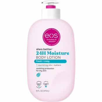 A pink bottle of EOS Shea Better 24H Moisture Body Lotion with a white pump. The label highlights "fresh + cozy," nourishing oils and butters, and soothing protection for dry skin. Size: 16 fl oz (473 mL).