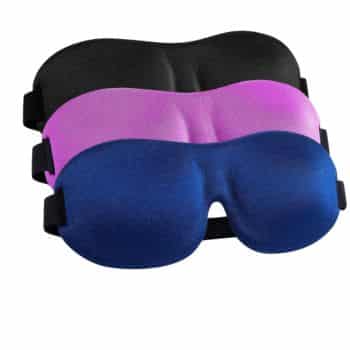 Three contoured sleep masks in black, purple, and blue are stacked on top of each other. Each mask has an adjustable black elastic strap on the sides.