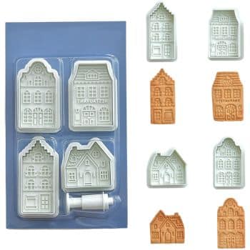 Plastic cookie cutter set shaped like different houses, perfect for making my favorite Christmas cookies. The set includes four house designs and a white plunger tool, with matching embossed cookies beside each cutter, all displayed on a blue background.