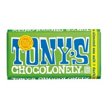 A green wrapper of Tony's Chocolonely dark chocolate with almond sea salt. The large blue and white logo is on the front, with a yellow seal that reads "Tony's Open Chain.