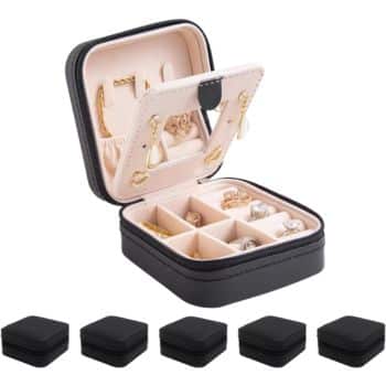Small black jewelry box with a beige interior, open to display gold earrings and rings stored in compartments. Five closed boxes are shown in a row beneath the open one.