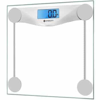 Digital bathroom scale with a glass platform, metal accents, and a blue backlit LCD screen displaying “0.0 lb.” The brand name “Etekcity” is visible below the display.