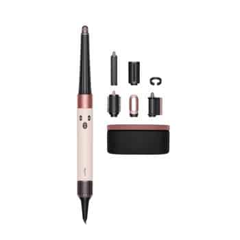 A hair styling tool with a pink and black handle shown alongside multiple interchangeable attachments and a rectangular storage case, all arranged neatly on a white background.