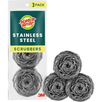 A package labeled "Scotch-Brite Stainless Steel Scrubbers, 3 Pack" is shown next to three coiled stainless steel scrubbers placed outside the package.
