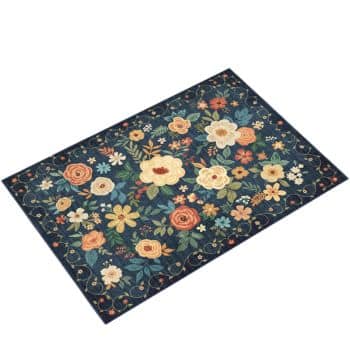 A rectangular rug with a dark blue background, featuring a colorful floral pattern with various flowers in shades of yellow, orange, cream, and green.