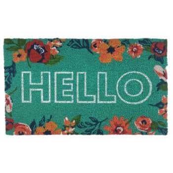A rectangular green doormat with the word "HELLO" in large white letters, surrounded by colorful floral designs along the top and bottom edges.