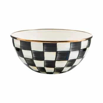 A ceramic bowl with a black and white checkerboard pattern and a gold-rimmed edge, set against a white background.