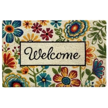 A rectangular doormat with colorful flowers and leaves surrounding the word "Welcome" written in script inside a bordered rectangle in the center.