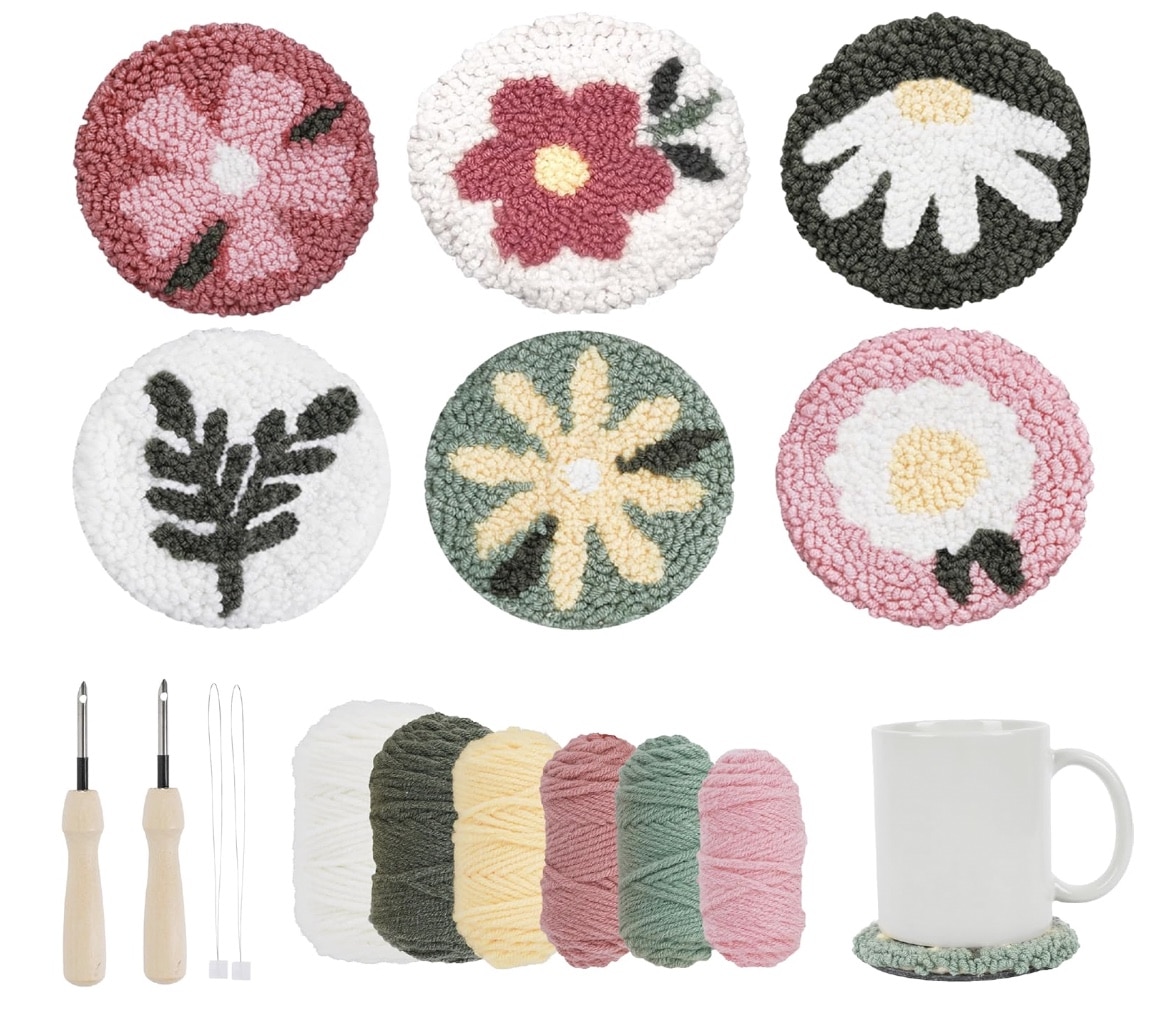 A set of six round, floral-patterned coasters made with punch needle crafting, yarn in five colors, two DIY tools, and a mug resting on a coaster are displayed on a white background.