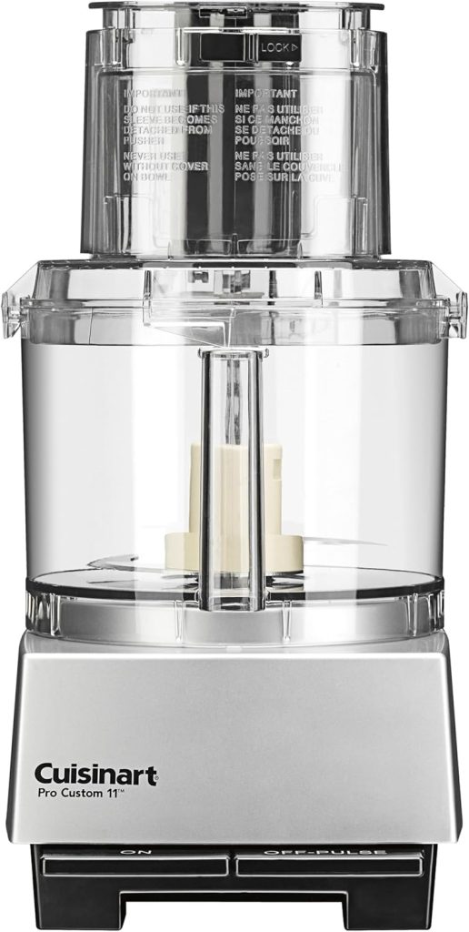 A Cuisinart Pro Custom 11-cup food processor—perfect for making your favorite chocolate covered quinoa recipe—features a clear plastic bowl, lid, feed tube, and sits on a sleek silver and black base with ON and OFF/PULSE buttons.