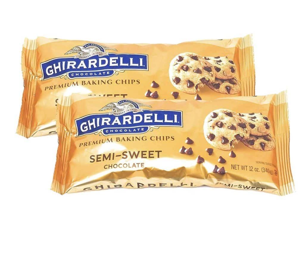 Two packages of Ghirardelli Premium Baking Chips, Semi-Sweet Chocolate—perfect for making heart shaped brownies recipe—feature images of chocolate chip cookies and scattered chips on the front. Each package is 12 ounces.